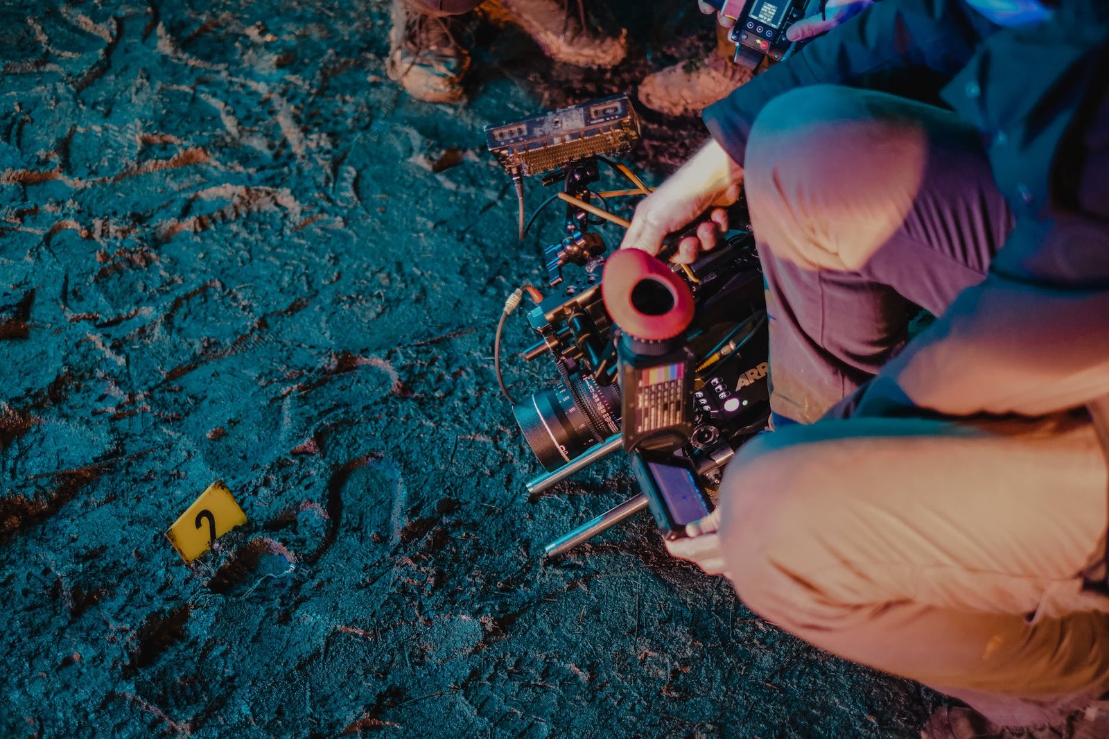 group of colleagues taking pictures of footsteps in mud